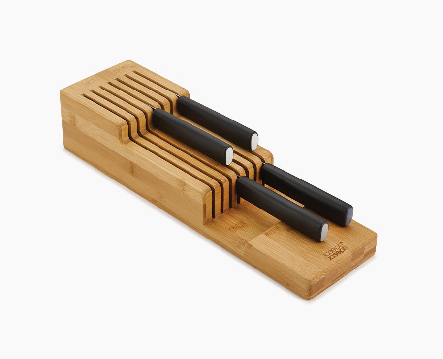 Joseph Joseph 85169. Two-tier bamboo knife organizer with example black-handled knives.