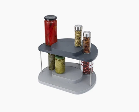 Joseph Joseph 85196. Gray two-tier rotating organizer with example food and spice jars.
